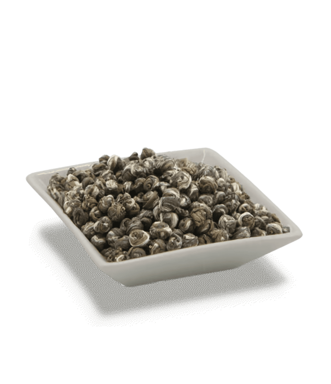 Square white container filled with dark brown tea leaves on a transparent background