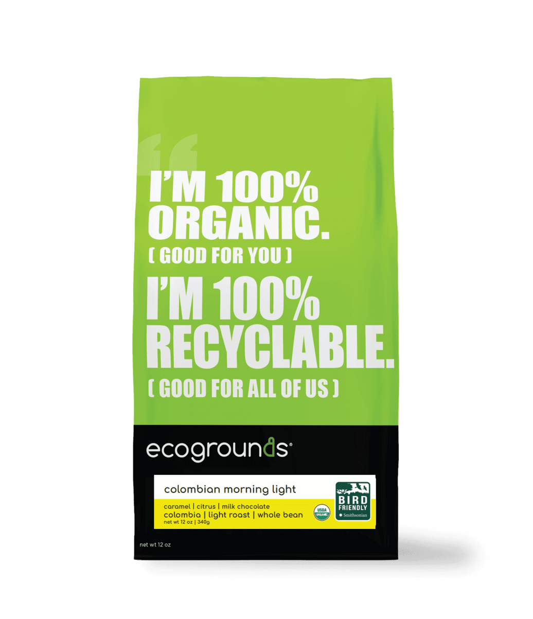 Green coffee bag of Ecogrounds Colombian Morning Light with text about organic and recyclable qualities on a transparent background