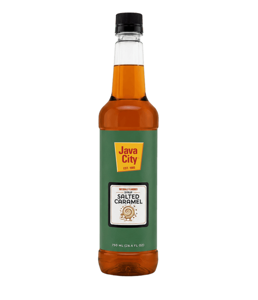 A bottle of Java City Salted Caramel Syrup against a solid dark green background. The syrup inside the clear bottle is amber brown, and the label is dark green with a yellow Java City logo.
