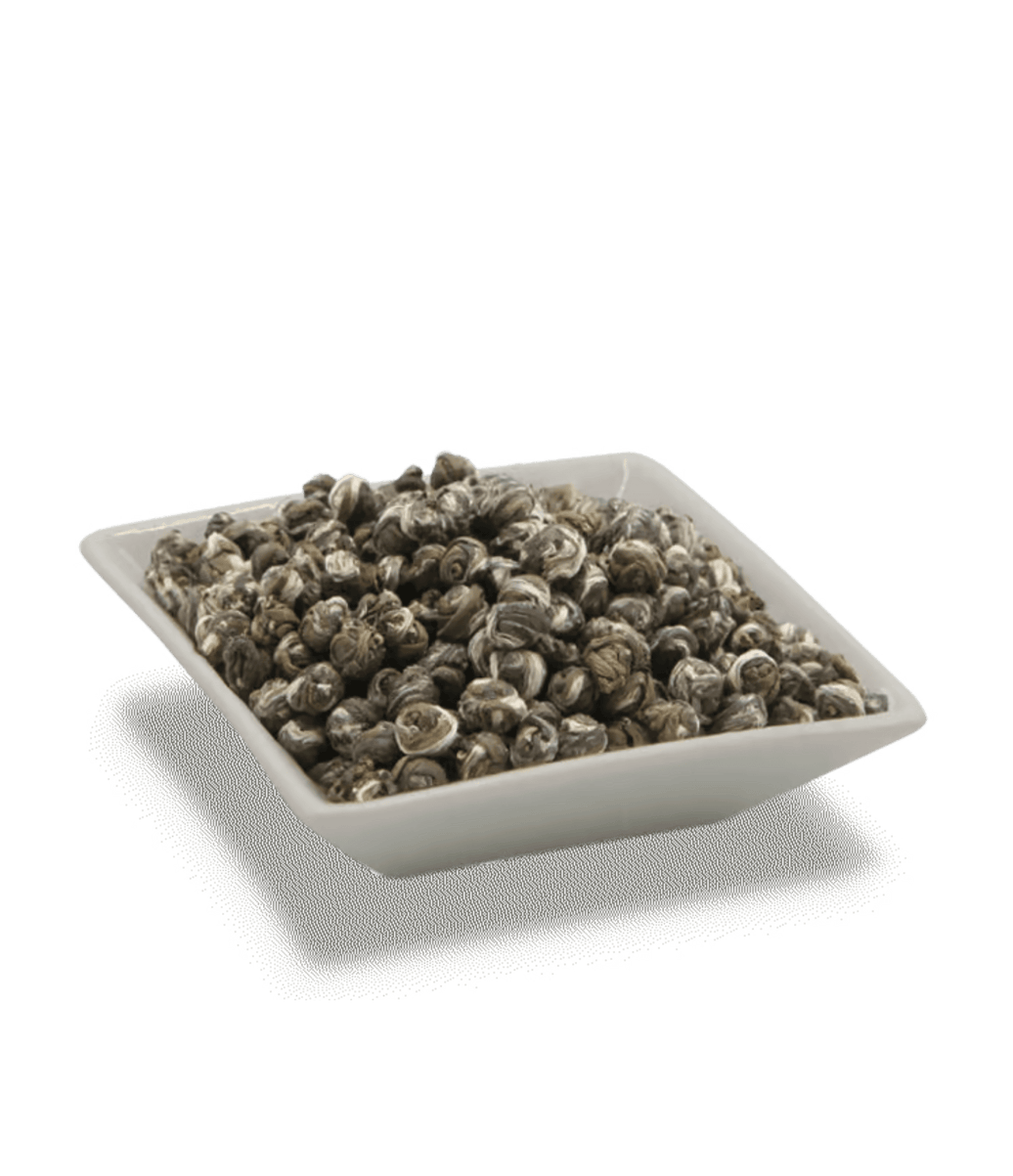 Square white container filled with dark brown tea leaves on a transparent background