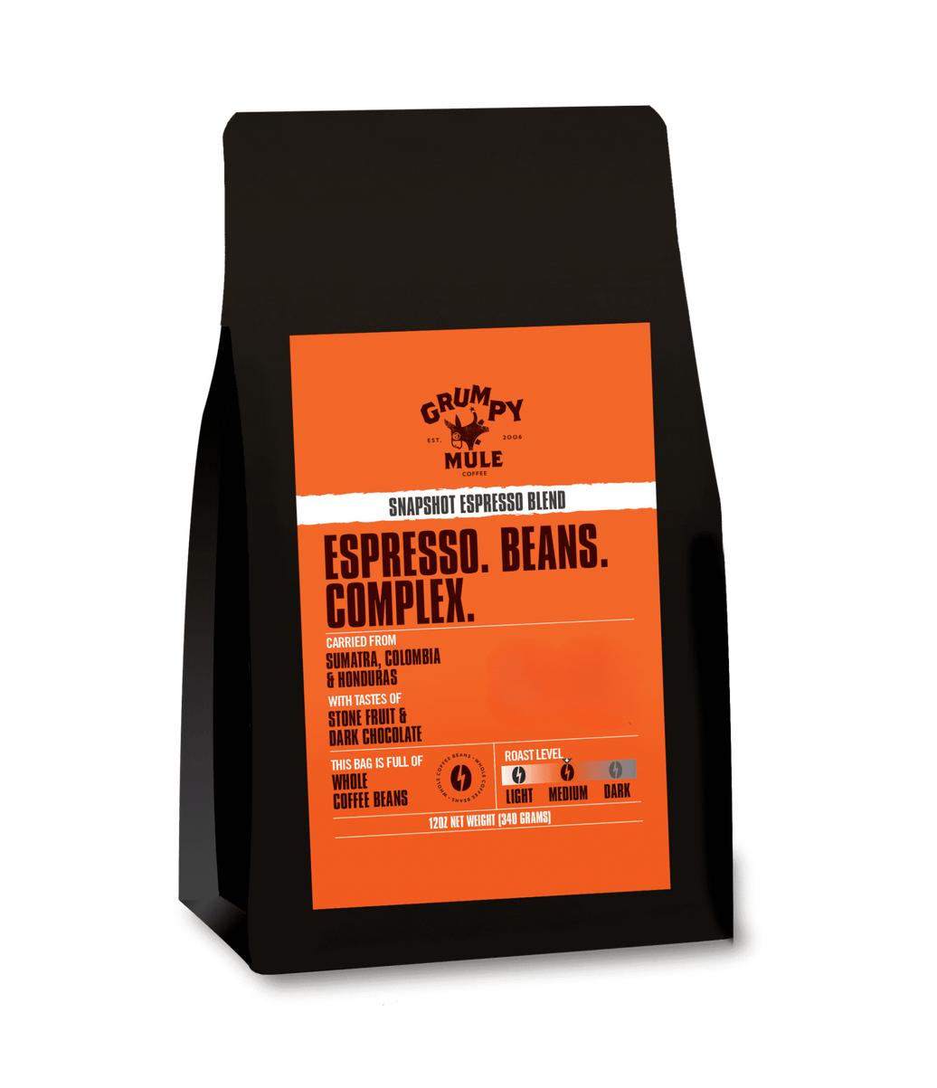 Coffee bag with orange label featuring 'Grumpy Mule' brand on a transparent background