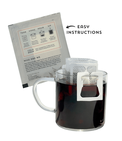 Clear mug with a white filter basket containing a tea bag, next to a printed instruction sheet on a transparent background. Showing Java City's single-serve pour overs.