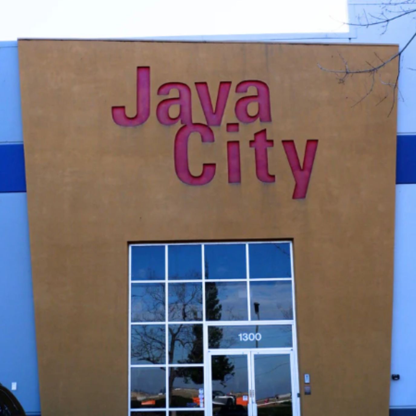 Java City sign on a building with a blue sky background