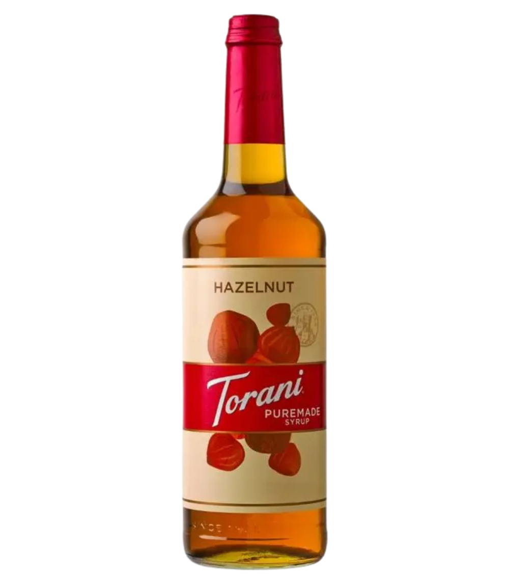 Bottle of Puremade Torani Hazelnut syrup on a white background