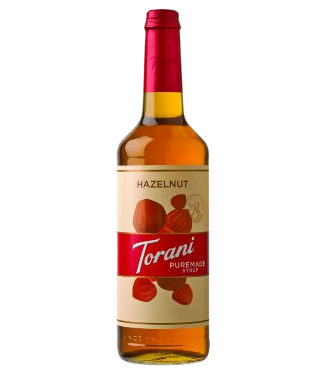 Bottle of Puremade Torani Hazelnut syrup on a white background